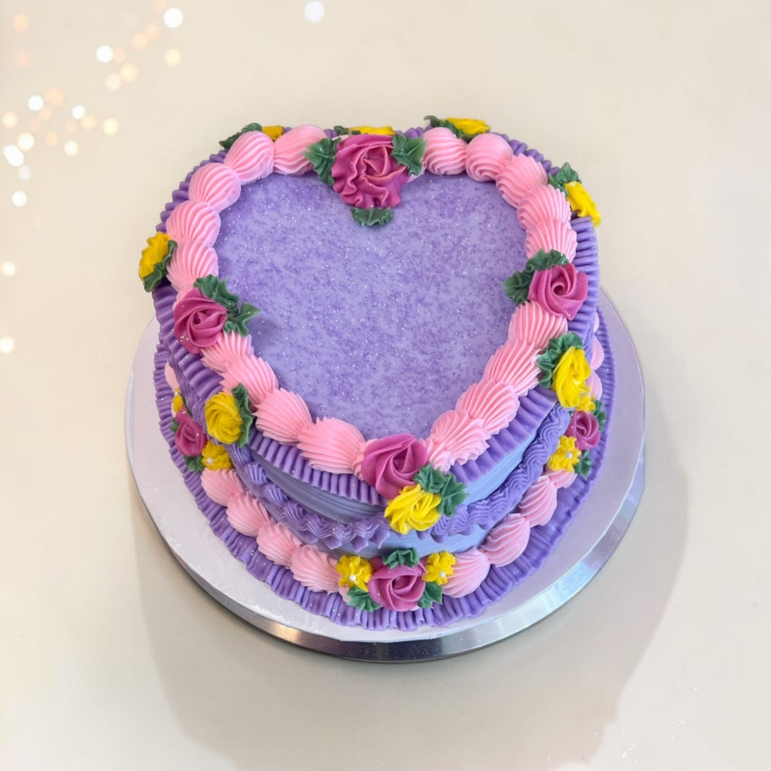Purple with Flower accents Heart shaped cake