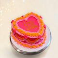 Orange and two shades of Pink Heart shaped cake