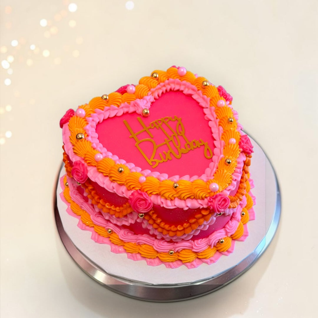 Orange and two shades of Pink Heart shaped cake