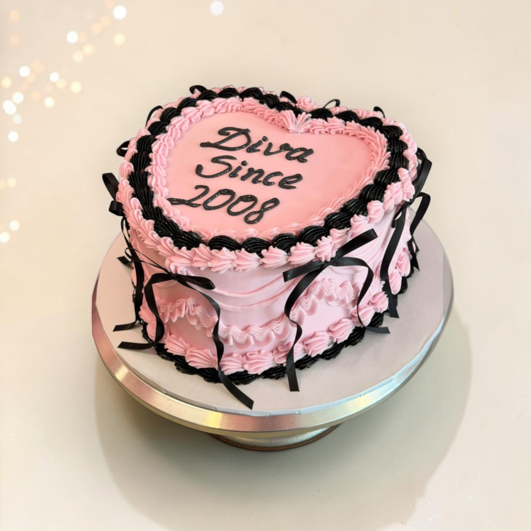 Pink with Black ribbons an borders Heart shaped cake